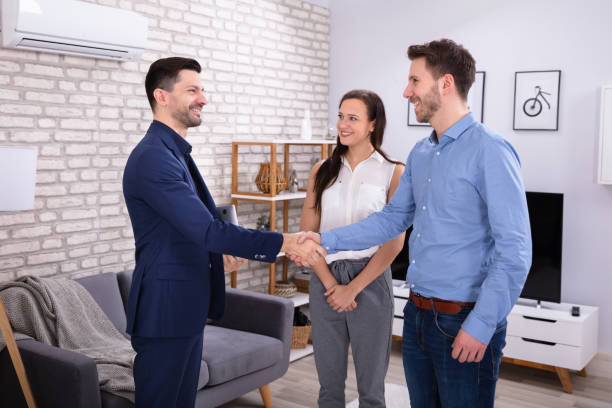 istock Real Estate Agent Shaking Hands With His Clients 1144377622