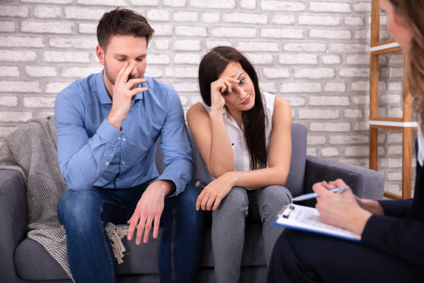 istock Young Psychologist Talking With Depressed Couple 1144377636