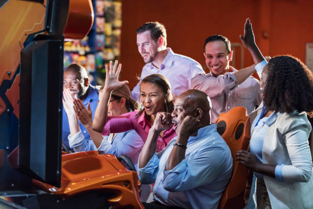 istock Team building at amusement arcade, playing racing game 1144377770