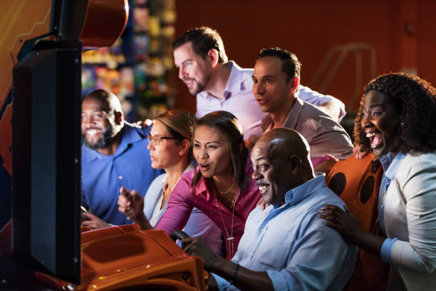 istock Team building at amusement arcade, playing racing game 1144378503