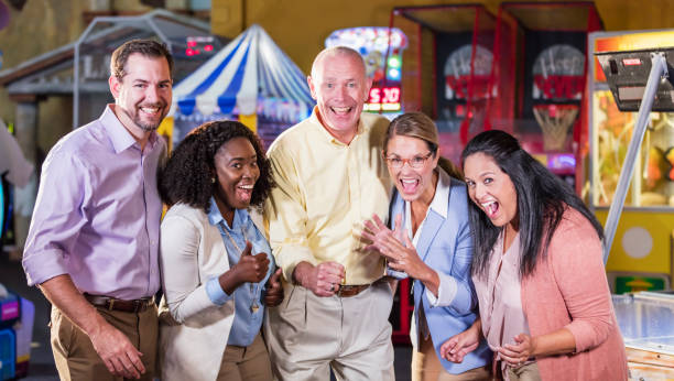 istock Corporate team building at amusement arcade 1144378945