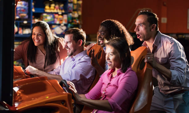 istock Team building at amusement arcade, playing racing game 1144378947