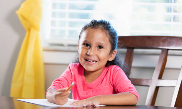 istock Little Hispanic girl doing homework 1144380230