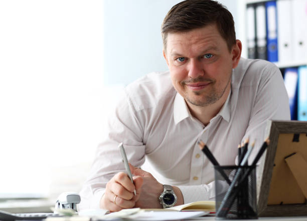istock Handsome male clerk ar office working table looking in camera 1144382838