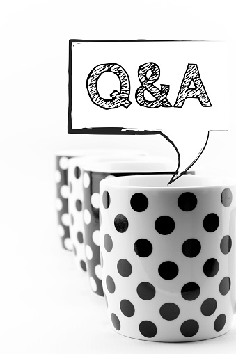 Coffee mugs with speech bubbles Q&A isolated on white background