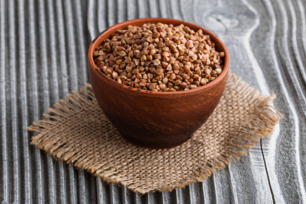 istock Grain buckwheat on a gray wooden background 1144387913