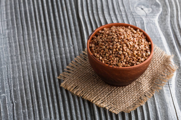 istock Grain buckwheat on a gray wooden background 1144387936
