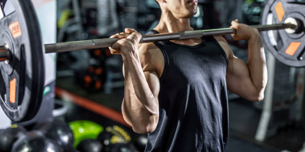 istock fit man make sport exercise with barbell. 1144388355
