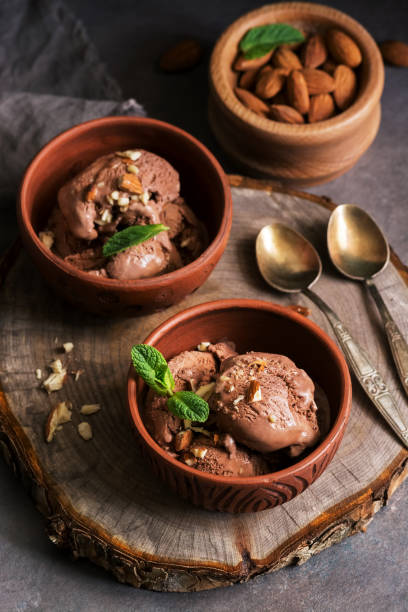 istock Homemade chocolate ice cream with almonds and mint leaves on a dark rustic table. Selective focus. 1144389090