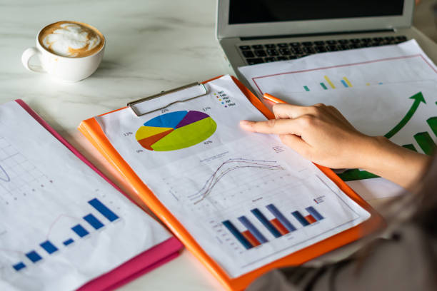 istock businesswomen  analyzing marketing strategy with statistic graph on the table 1144389166