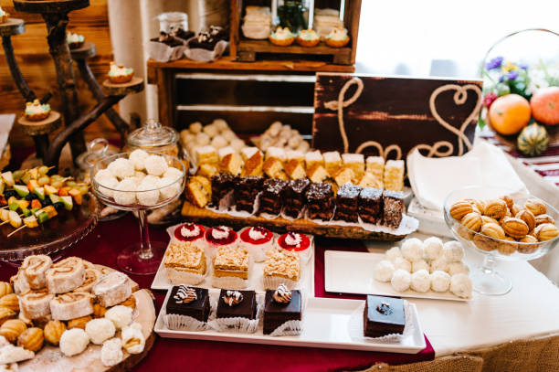 istock Wedding candy bar. Decorations made of wood and served on the festive table setting in rustic style for wedding ceremony. Wooden stage, wall on the restaurant for party. 1144389227