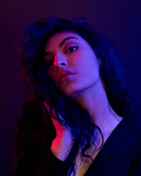 istock Attractive female in blue and red light 1144392368