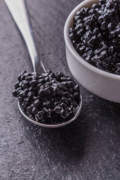 istock black caviar in a bowl on a dark stone background 1144393154