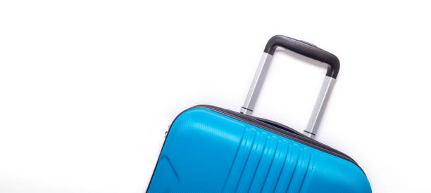 istock Blue suitcase on white background Creative Summer holidays, vacation, travel concept Banner 1144393175