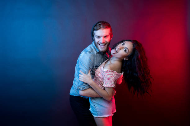 istock Young attractive couple standing in front of black background 1144393433
