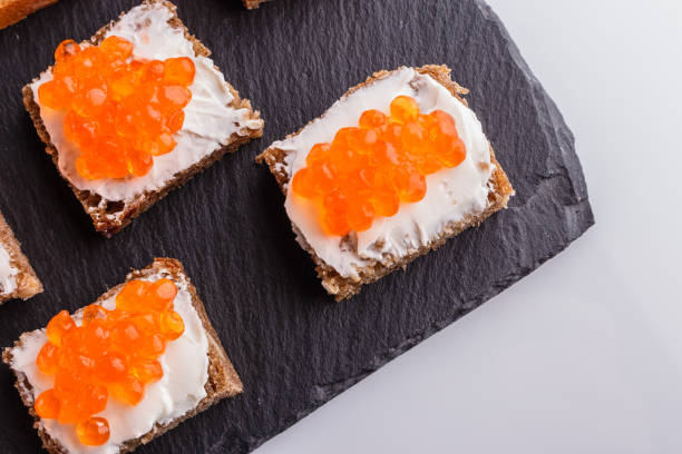 istock Snack with red and black caviar on a stone plate 1144393439