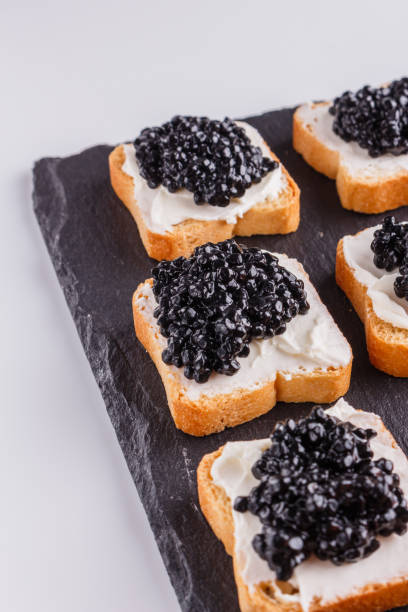 istock Snack with red and black caviar on a stone plate 1144393475