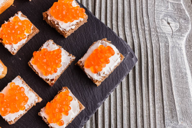 istock Snack with red and black caviar on a stone plate 1144393581