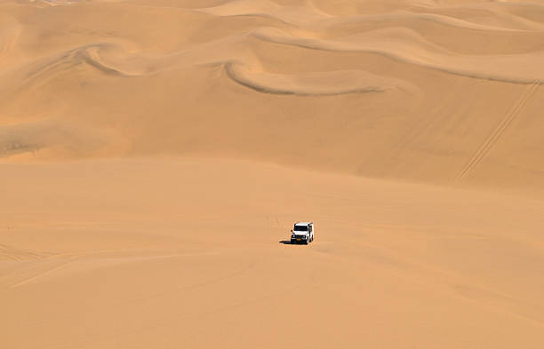 istock Off-road vehicle coming down the sand dunes, Sandwich Harbour,Namibia 114439595