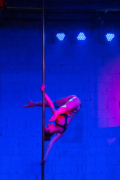 istock Woman pole dancer pole dancing on the stage 1144396170