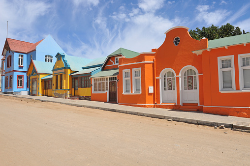 Row of colorful,orange,yellow,blue houses   in Luderitz, a small town in south - west Namibia.