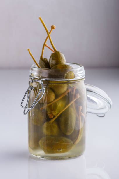 istock Pickled capers on a white acrylic background 1144396704