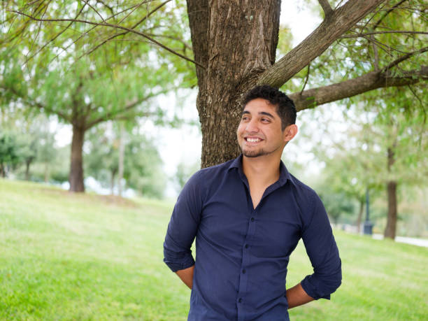 Latin young man standing outside and smiling