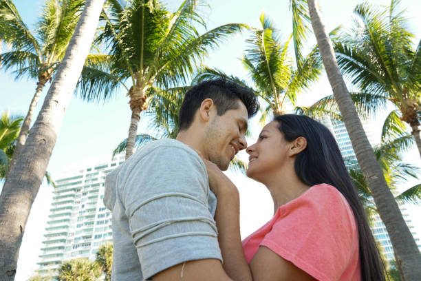istock Young couple outdoors hugging each other smiling 1144399966