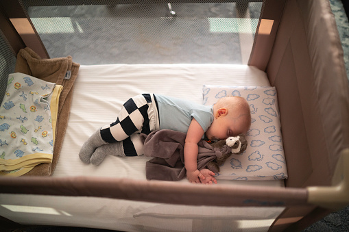 Cute little baby sleeping in crib at home. Bedtime