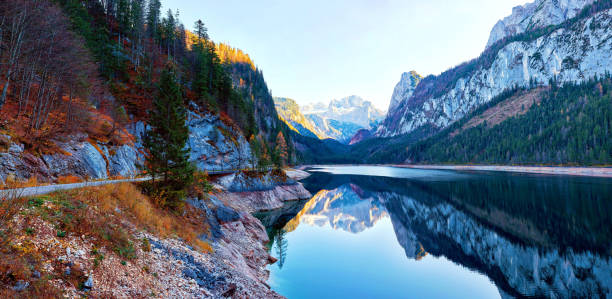 istock Beautiful Gosausee lake landscape with Dachstein mountains, forest, clouds and reflections in the water in Austrian Alps 1144402422