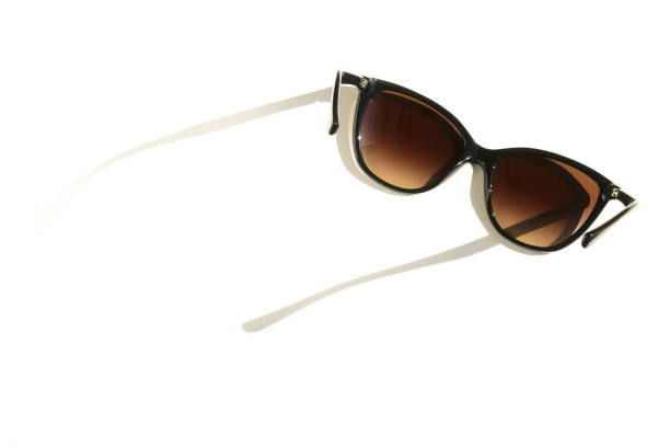 istock Black stylish sunglasses on a white background  with sunlight shadows .copy space. creative concept 1144402570
