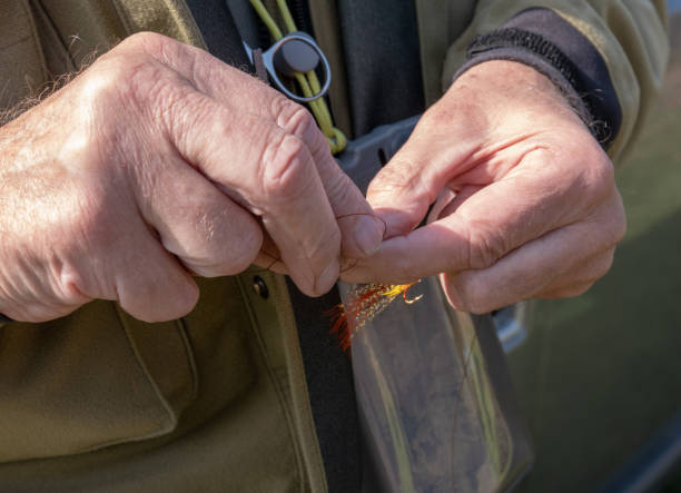 istock A man attaching a hand tied salmon fly to his line 1144403017