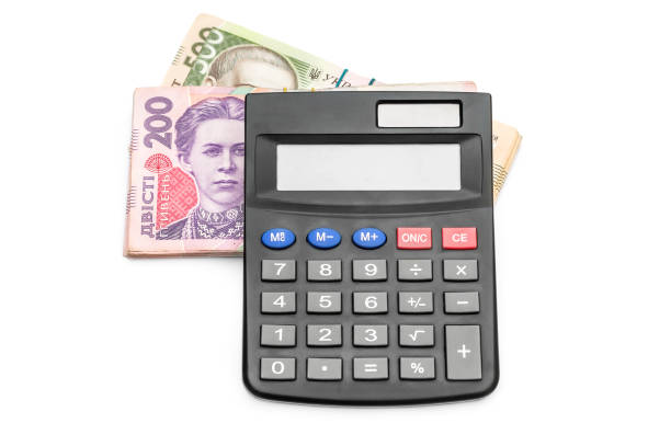 istock Calculator with ukrainian money on white. 1144403124