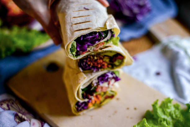 istock appetizing vegetarian rolls with vegetables and beans on the wooden kitchen board on dark background 1144404356