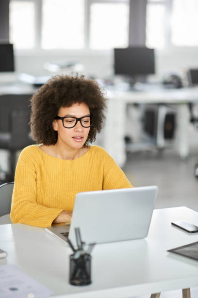 Serious businesswoman using laptop.