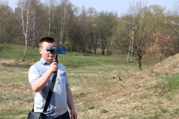 istock A young man videotaping on a smartphone. Uses gimbal to get smooth footage. Closely watching the movie shooting. 1144405184