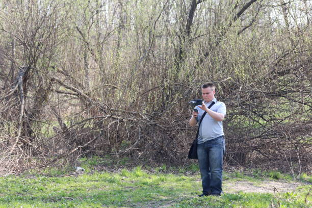 istock A young man videotaping on a smartphone. Uses gimbal to get smooth shots. Controls the recording by touching the screen. 1144405234