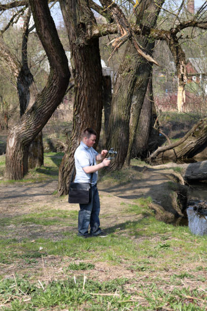 istock A young man videotaping on a smartphone. Uses gimbal to get smooth footage. Closely watching the movie shooting. 1144405244