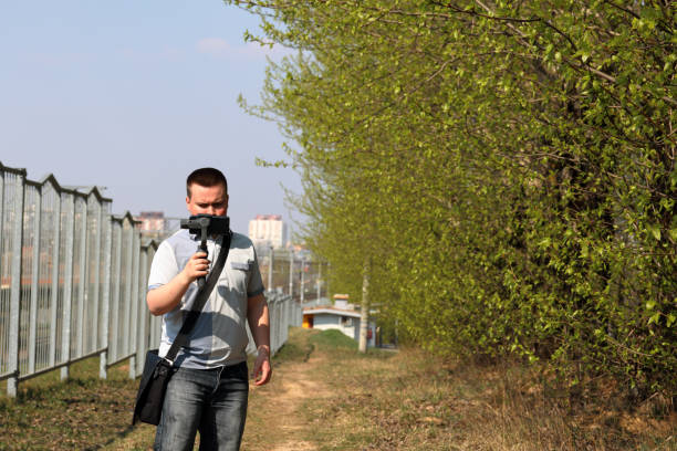 istock A young man videotaping on a smartphone. Uses gimbal to get smooth footage. Closely watching the movie shooting. 1144405300
