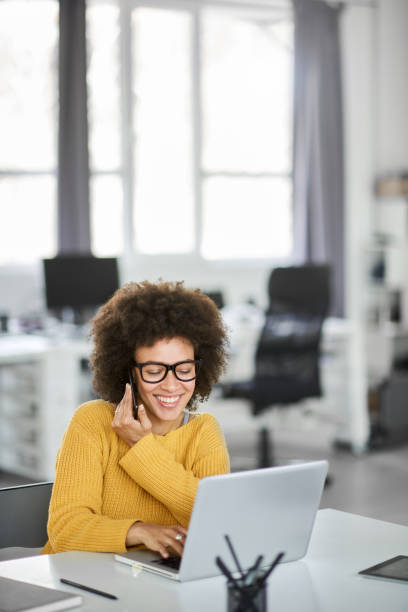 istock Businesswoman using smart phone and laptop while sitting in office. 1144405497