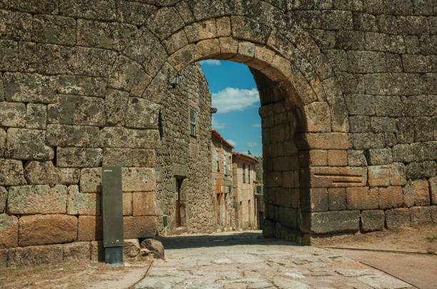 istock Old house seen through arch gate from a stone wall 1144406323