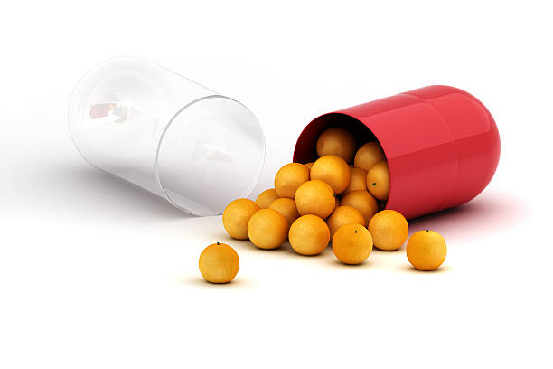 витамин концепции - capsule vitamin pill red orange стоковые фото и изображения