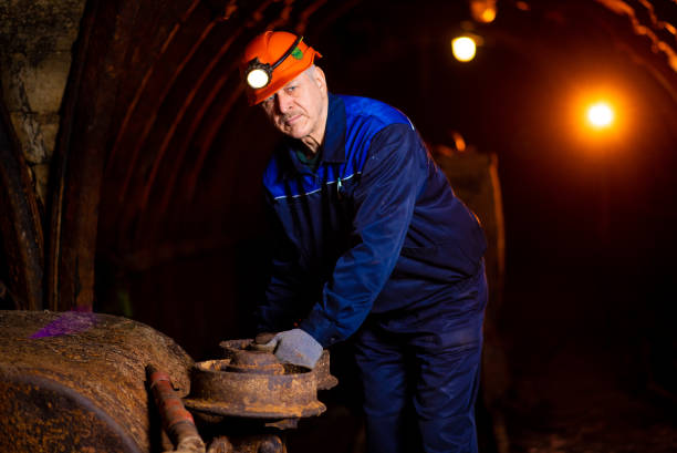 istock man in a protective suit and helmet. Miner in mine 1144406396