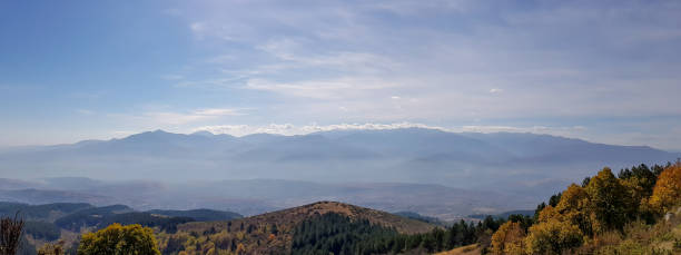 istock A panorama of mountains silhouette with mist. 1144406512