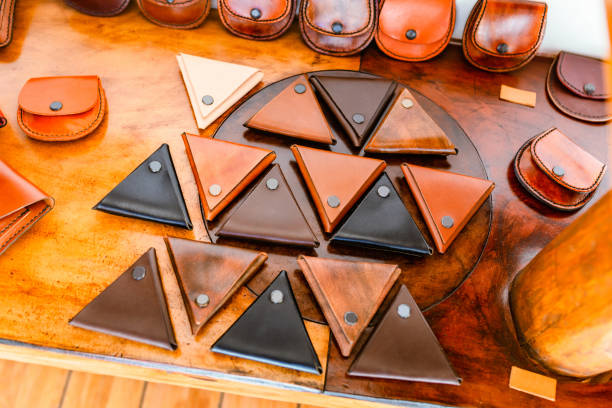 istock Set of hand made leather triangle wallets in workshop 1144406543
