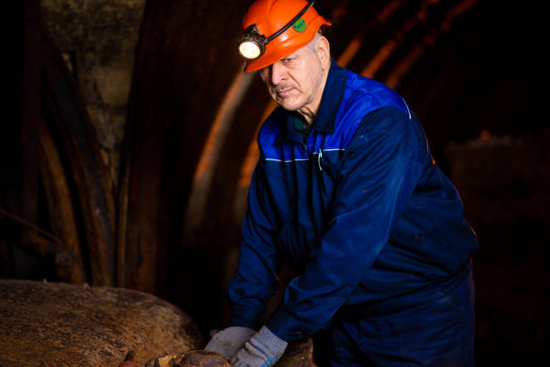 istock man in a protective suit and helmet. Miner in mine 1144406699