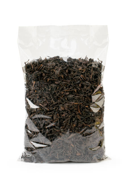 istock Black tea leaves in a package on a white, isolated. 1144407782