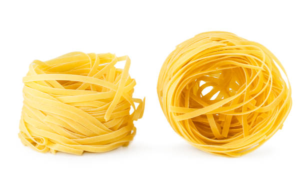 istock Two nests of pasta close up on a white background. 1144408107