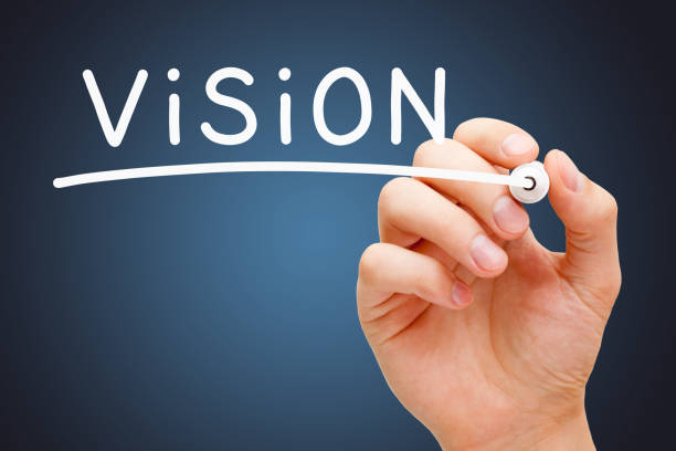 Word Vision Handwritten With White Marker Hand writing the word Vision with white marker on transparent wipe board over dark blue background. ideology stock pictures, royalty-free photos & images