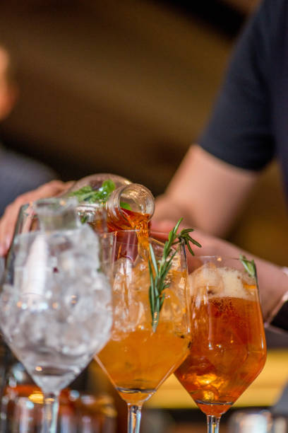 istock female bartender preparing aperol cocktail in a cocktail bar 1144409004